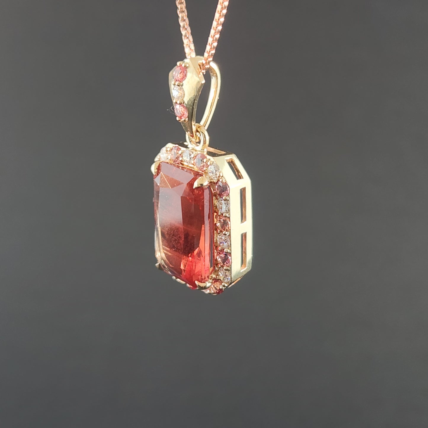 5.02 ct Oregon Sunstone Pendant set in 14 kt yellow gold with sapphires and Diamonds.