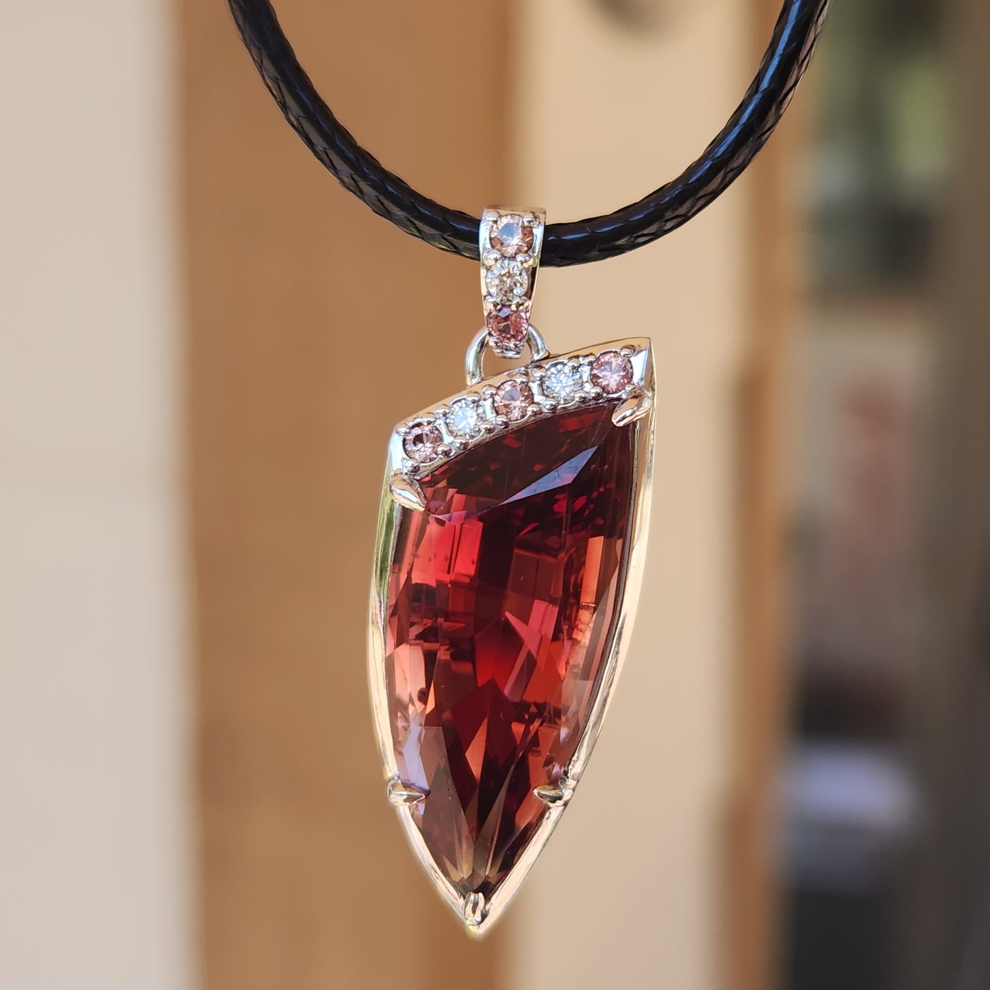 15.22 ct Oregon Sunstone Pendant set in 14 kt Gold with Sapphires and diamonds.