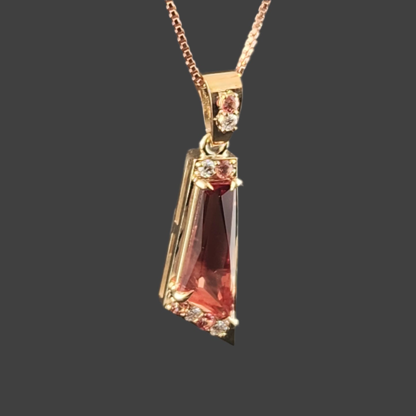 2.89 ct Oregon Sunstone Pendant set in 14 kt yellow Gold with Sapphires and Diamonds.